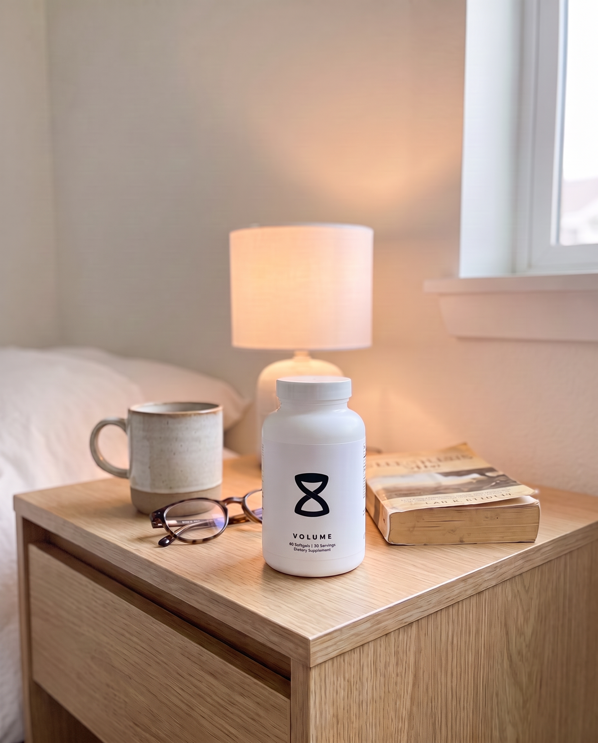 The Holy Grail of Volume bottle on a bedroom nightstand